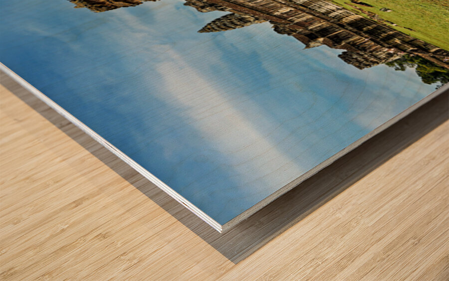 Angkor Wat temple complex with green grass and blue sky. Wood print