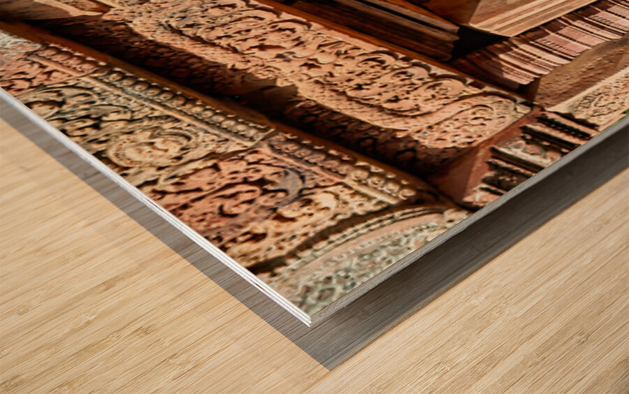 Ancient Cambodian temple with intricate carvings and stone statu Wood print