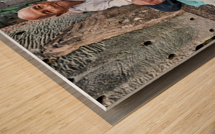 Elderly person selling goods at ancient temple ruins. Wood print