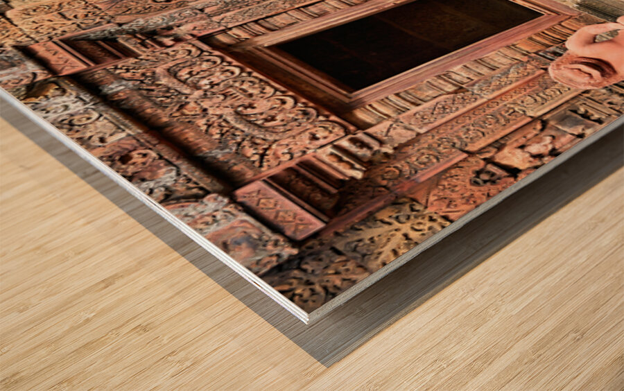 Ancient Cambodian temple with intricate red sandstone carvings a Wood print