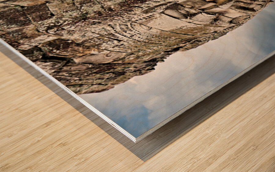 Ancient stone faces carved into Bayon Temple Cambodia. Wood print