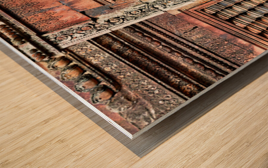 Ancient temple wall with intricate reddish stone carvings and co Wood print