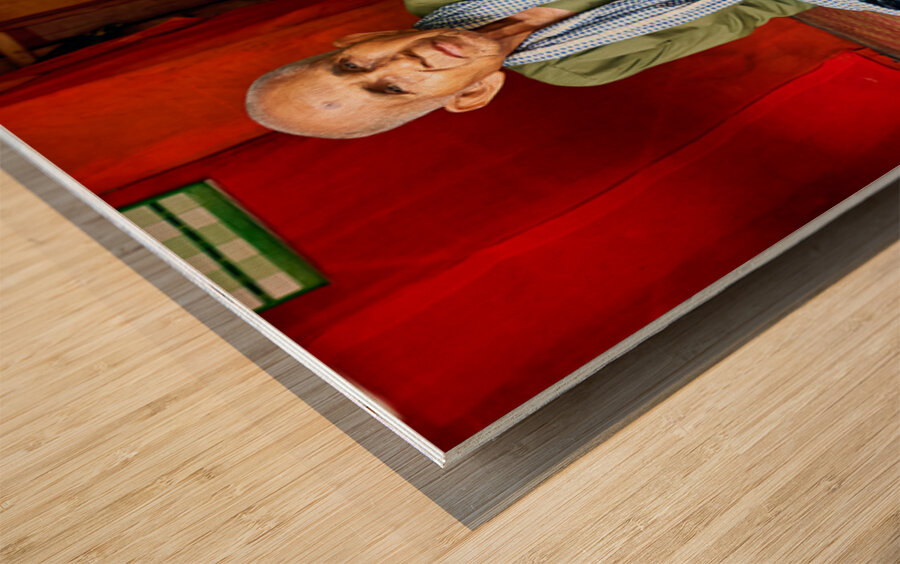 Elderly person sitting on floor in rustic dwelling. Wood print