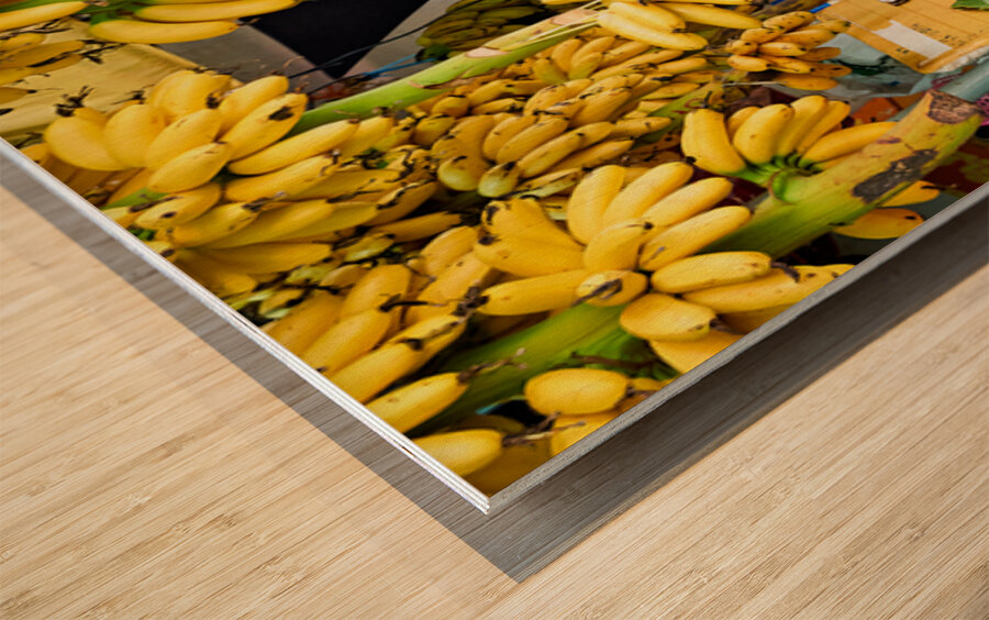 Market vendor surrounded by abundant yellow bananas. Wood print
