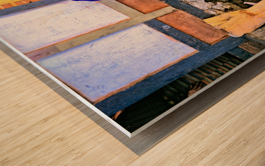 Smiling elderly woman in traditional dress leaning on wooden tab Wood print