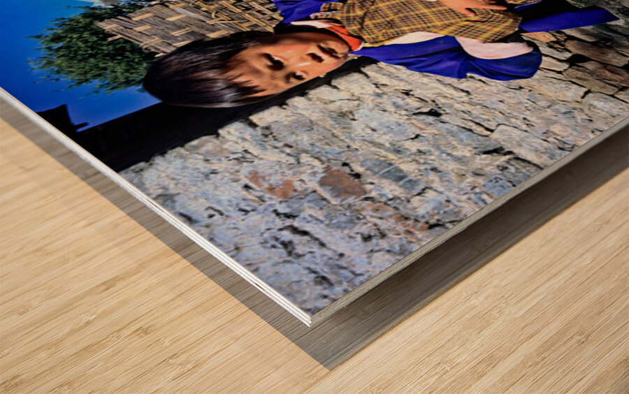 Young child in traditional Bhutanese dress in village. Wood print