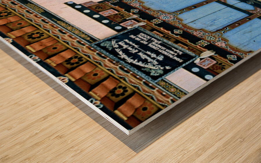 Phallus painting on a building wall with windows and shop sign. Wood print