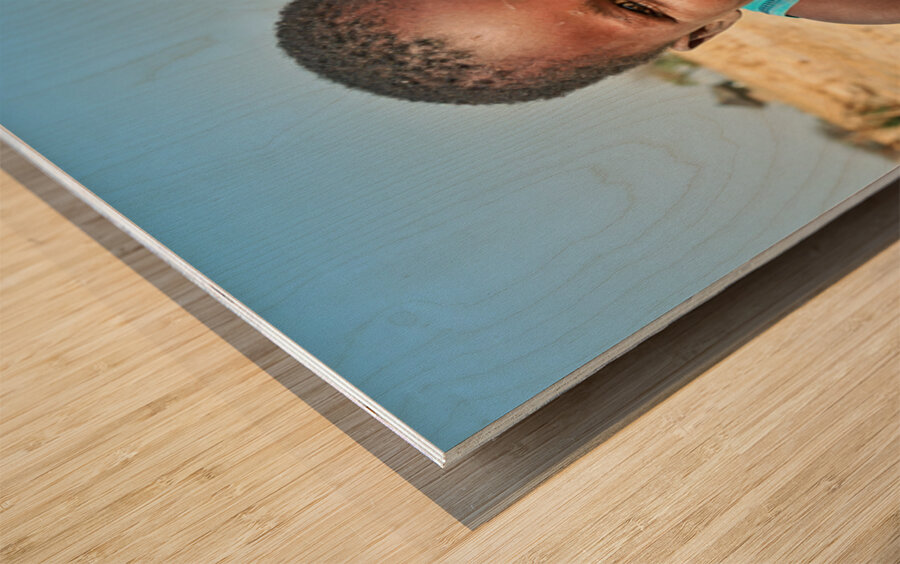 Joyful boy in Kavango Region of Namibia enjoys a moment outside Wood print