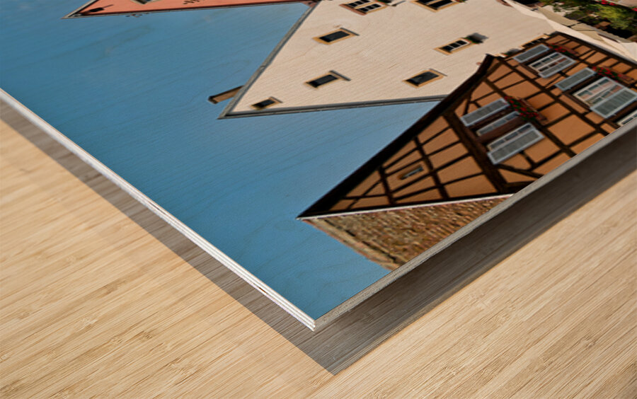 Visitors enjoy Saint Leon square in Eguisheim Alsace on a sunny Wood print