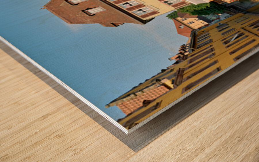 Visitors stroll by timber framed houses along the canal in Colma Wood print