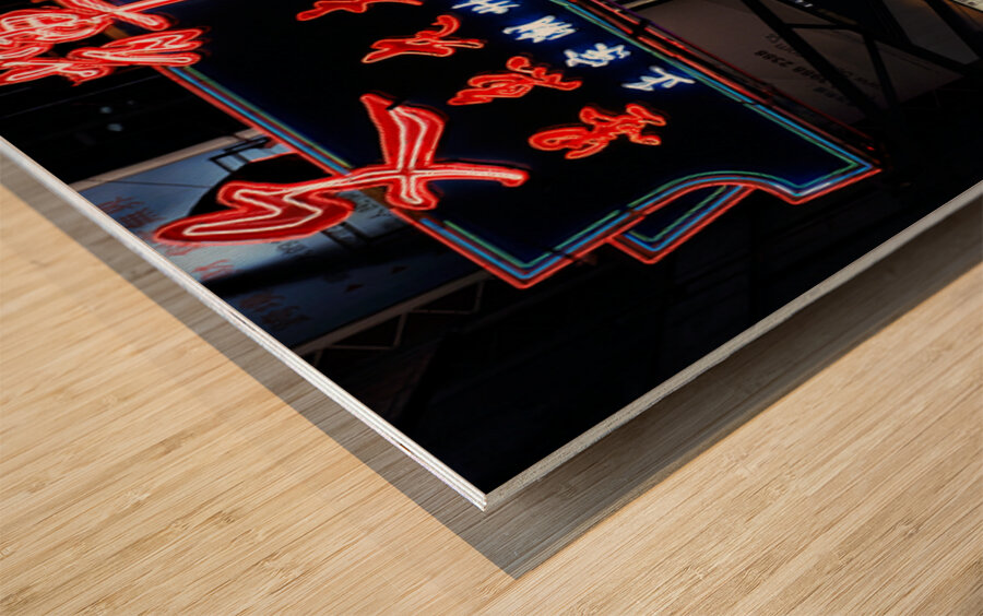 Neon signs light up a busy street in Hong Kong at night Wood print