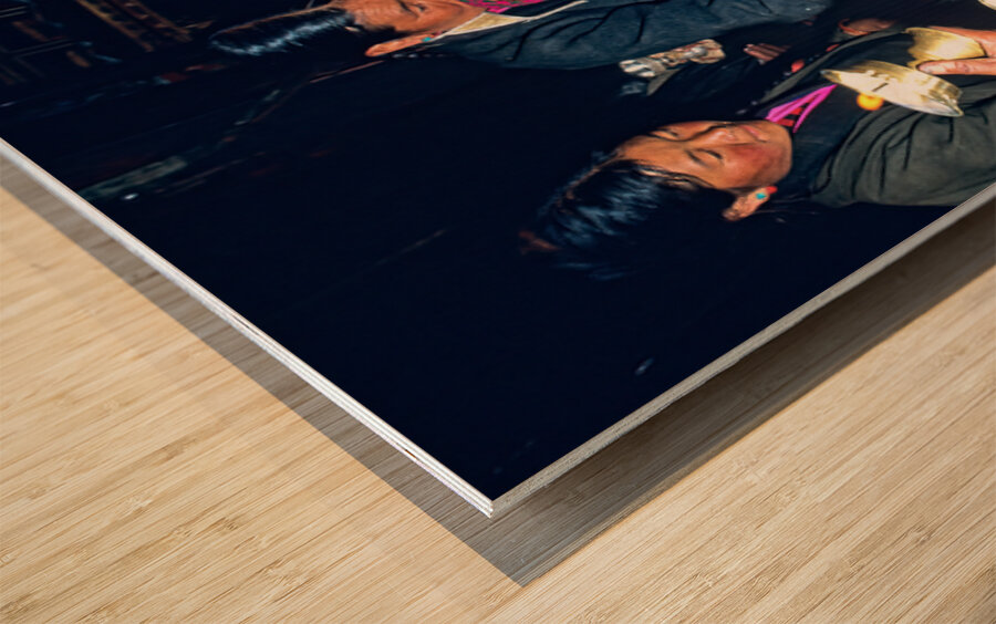 Lighting butter lamps during a ceremony in Tibet Wood print