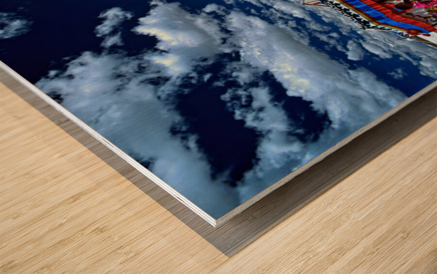 Colorful Tibetan tent with people under a cloudy sky in Tibet Wood print