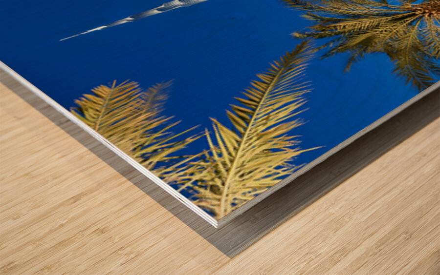 Burj Khalifa stands tall at night with light reflections in Duba Wood print