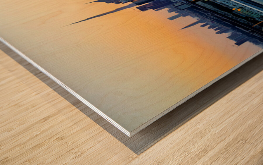 Swimming in infinity pool overlooking Dubai skyline at sunset Wood print