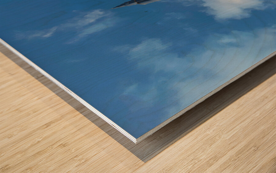 Burj Khalifa stands tall against a blue sky in Dubai UAE Wood print