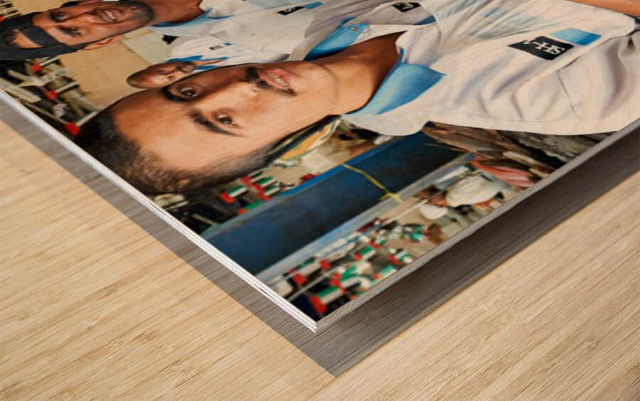Fish market scene with men at work in Dubai UAE Wood print