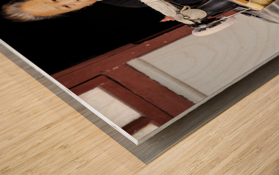 Elderly woman sews at machine in Shanghai China Wood print