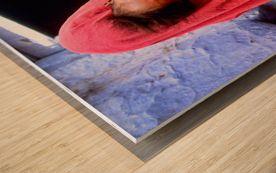 Mother carries sleeping child in India during daytime Wood print