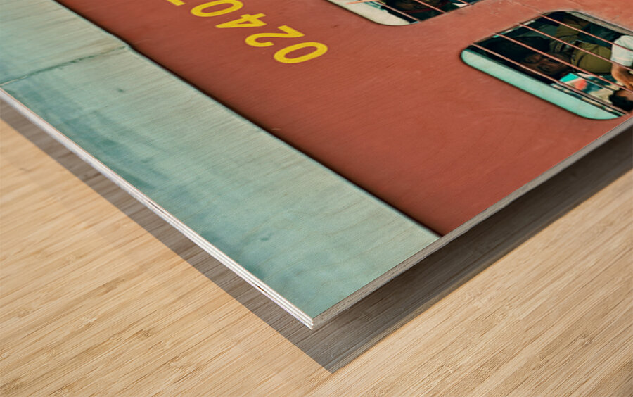 People travel on a train in Rajasthan India during the day Wood print