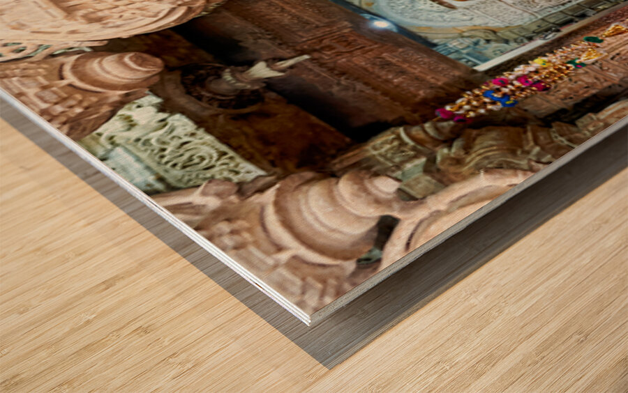 Hindu monk stands near statue in Jaisalmer Jain temple Wood print