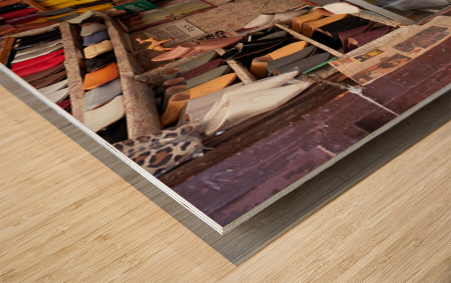 Moroccan babouches shoes in a Fez shop with a vendor Wood print