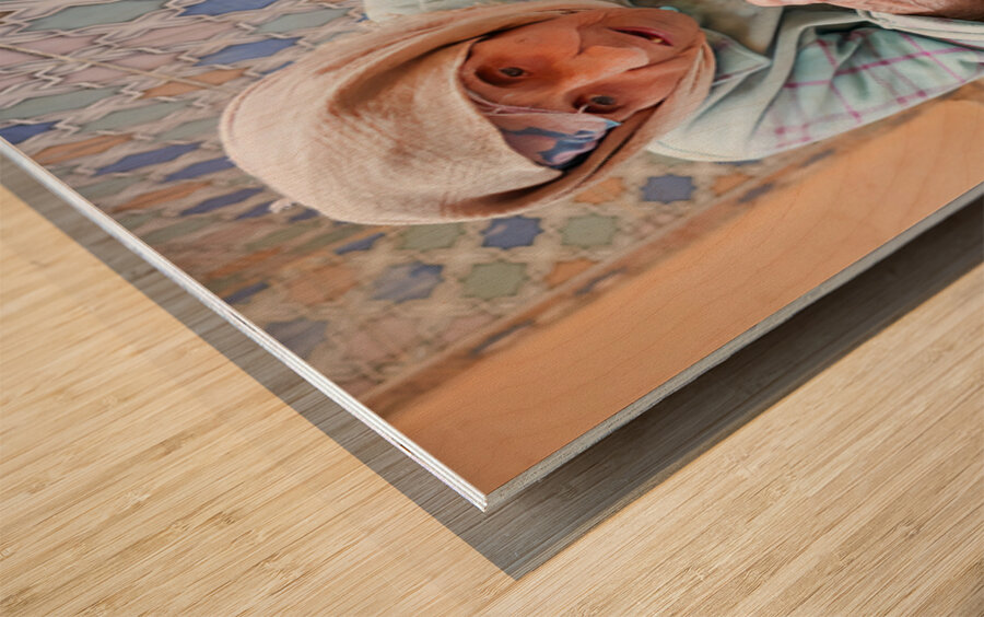 Beggar sitting in Fez Morocco with worn clothes and hands Wood print