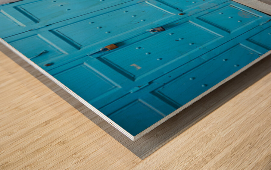 Portrait of a beggar sitting by a blue door in Fez Morocco Wood print