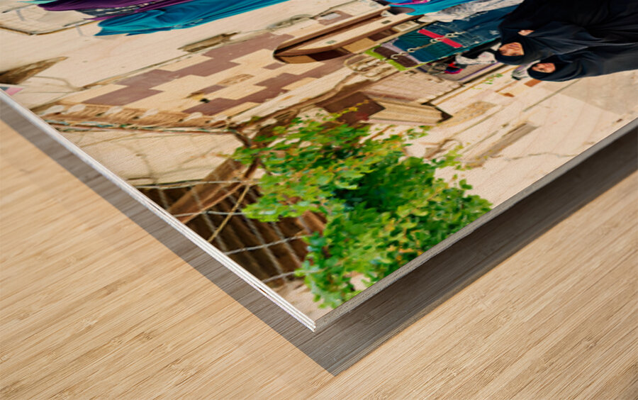 Women walk past colorful clothing displays in Damascus Syria Wood print