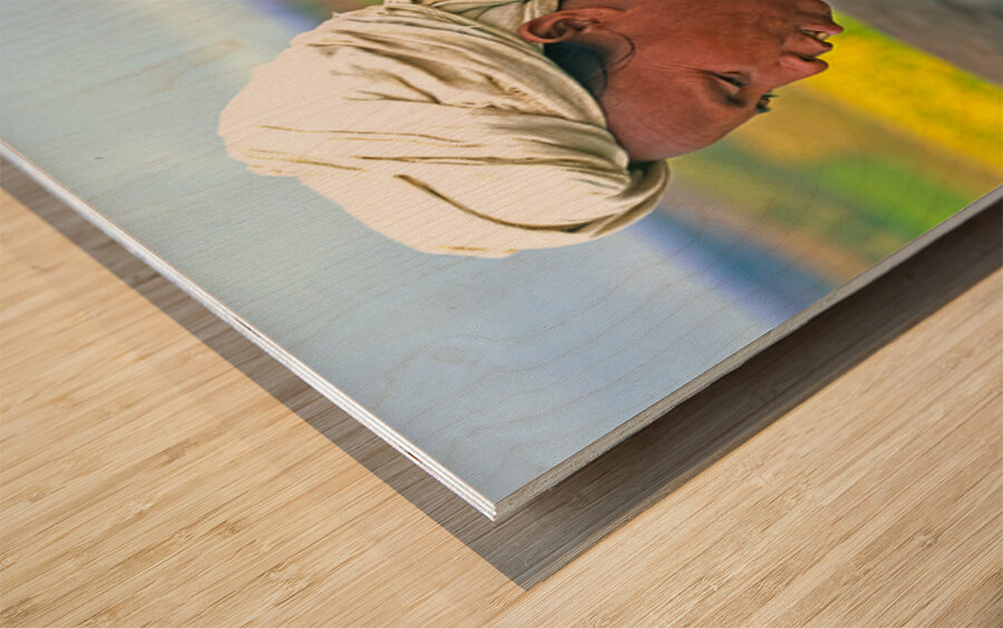 Woman carries son on her back in Myanmar fields Wood print