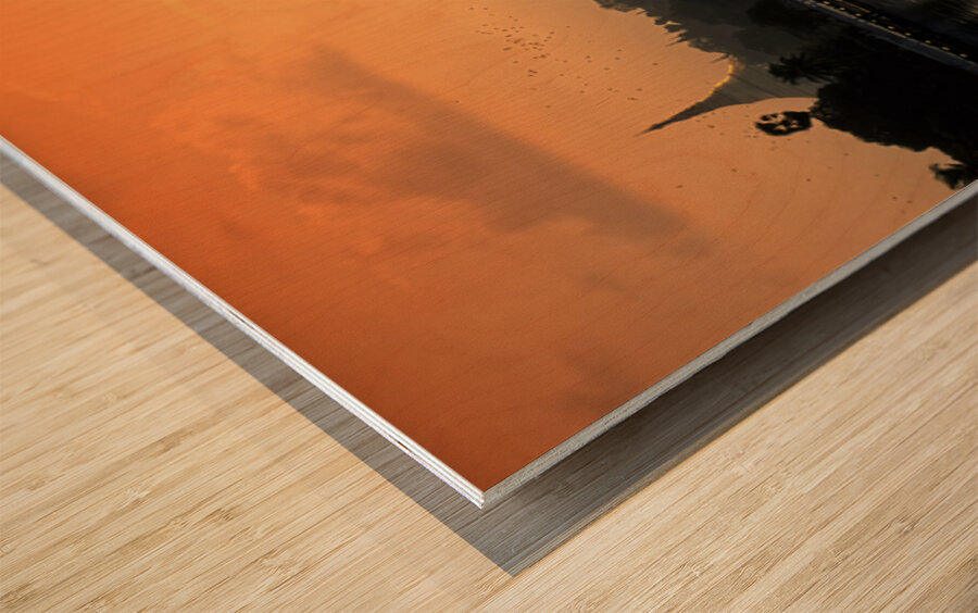 Sunset over the water in Yangon with palm trees and buildings Wood print