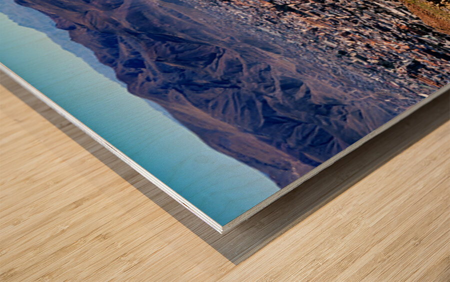 Panoramic view of a sprawling city in a mountain valley. Wood print