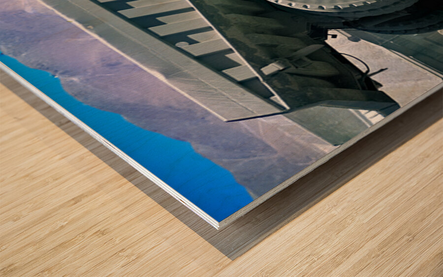 Giant mining dump truck in a dusty mountain quarry. Wood print