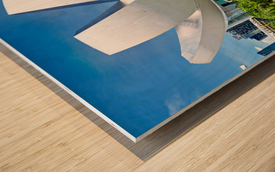 Visitors enjoy view of ArtScience Museum in Singapore near water Wood print