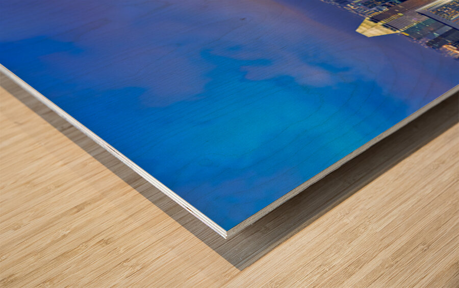 City lights shine in Marina Bay as sunset brings night activity Wood print