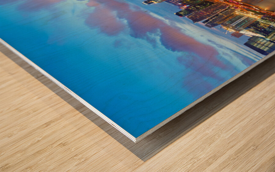 City lights shine over Marina Bay in Singapore at sunset Wood print