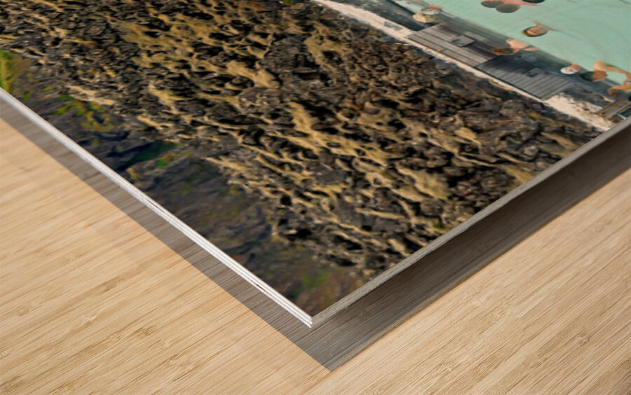 Visitors enjoy Grindaviks blue lagoon spa by day Wood print
