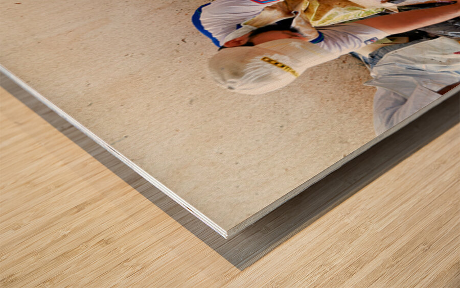 Fish market in Muscat Oman shows workers preparing fish Wood print