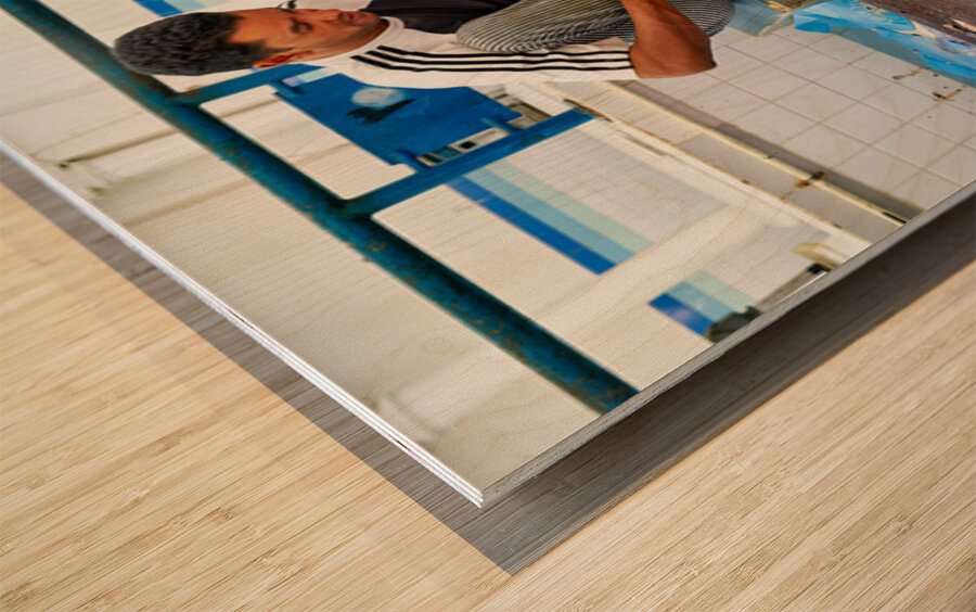 Fish seller prepares catch at Nizwa Oman fish market Wood print