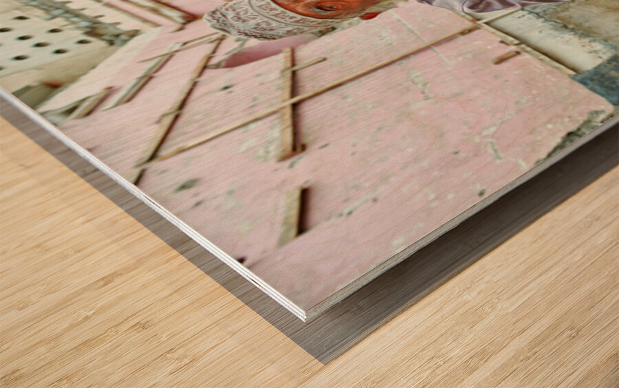 Old man sitting in a historical site in Muscat Oman Wood print