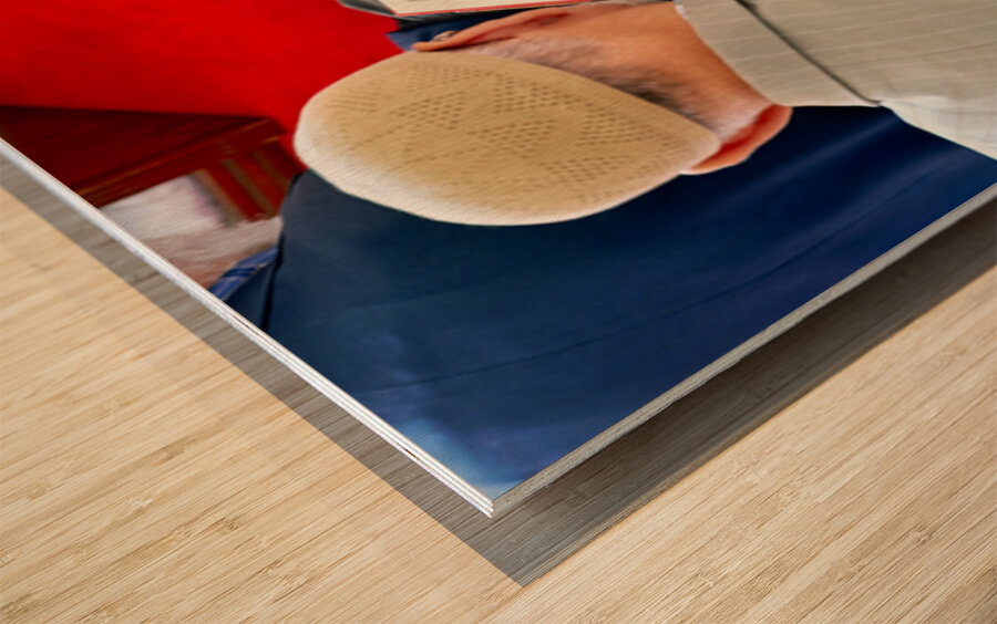 Man reading Quran inside Fatih Mosque in Istanbul Turkey Wood print