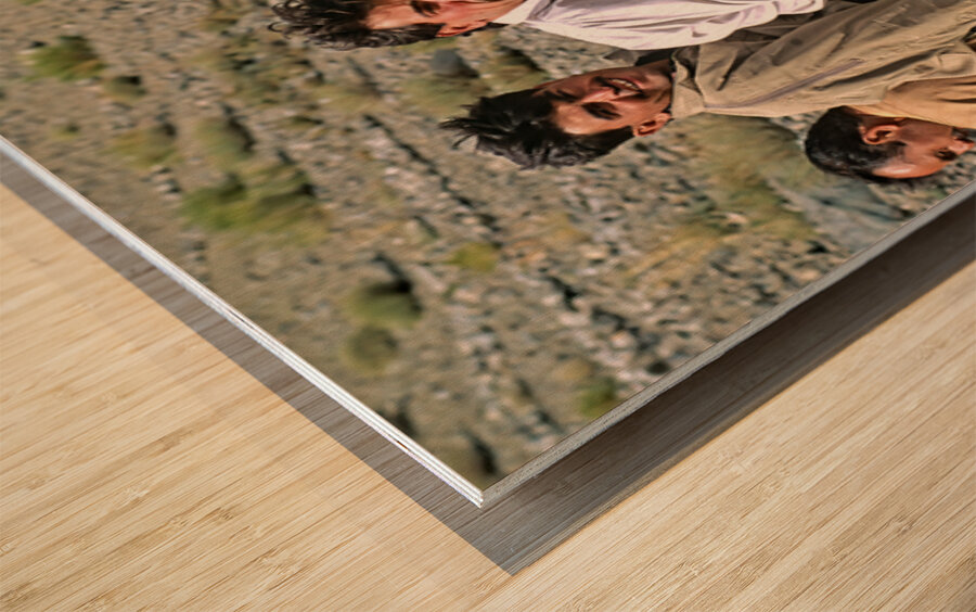 Group traveling on top of a van in Pakistans mountains Wood print