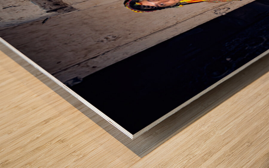 A woman holds her child in a Kalash village Wood print