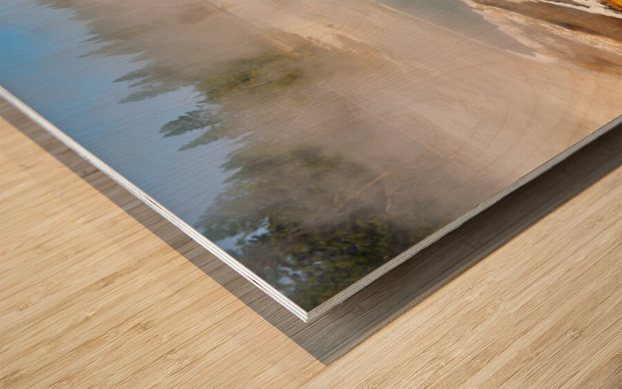 Steam rises from Abyss Pool as blue water reflects the surrounding landscape at Yellowstone National Park. Visitors explore the area nearby. Wood print
