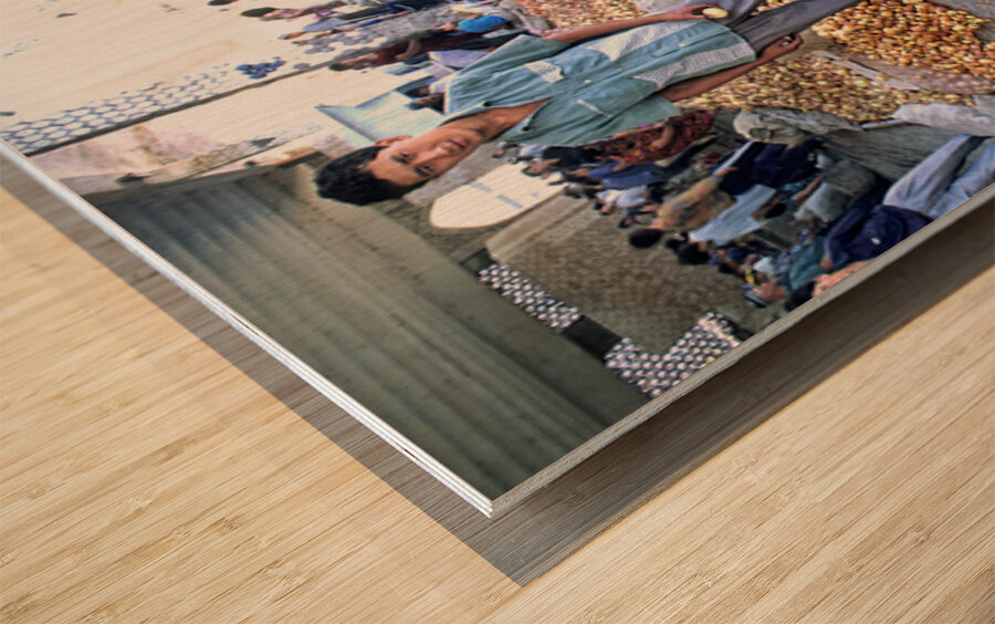 Young vendors sell onions in a market in Khiva Uzbekistan Wood print