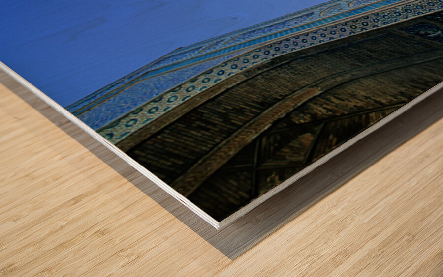 People rest near the tall minaret in Khiva Uzbekistan Wood print