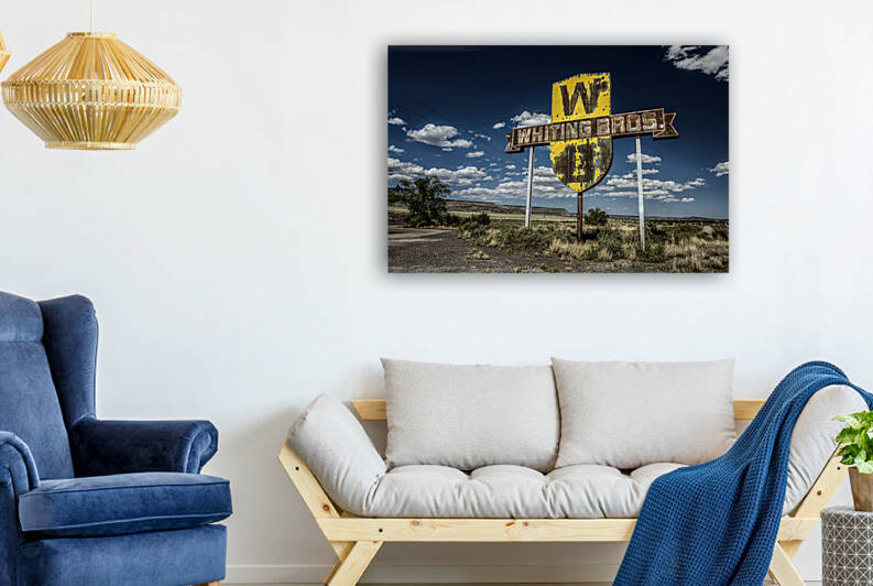 Vintage Whiting Bros sign above a removed gas station on Route 66 in New Mexico by Nick Fox
