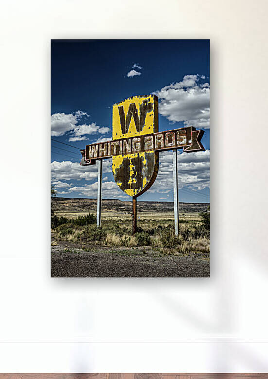 Vintage Whiting Bros sign above a removed gas station on Route 66 in New Mexico by Nick Fox