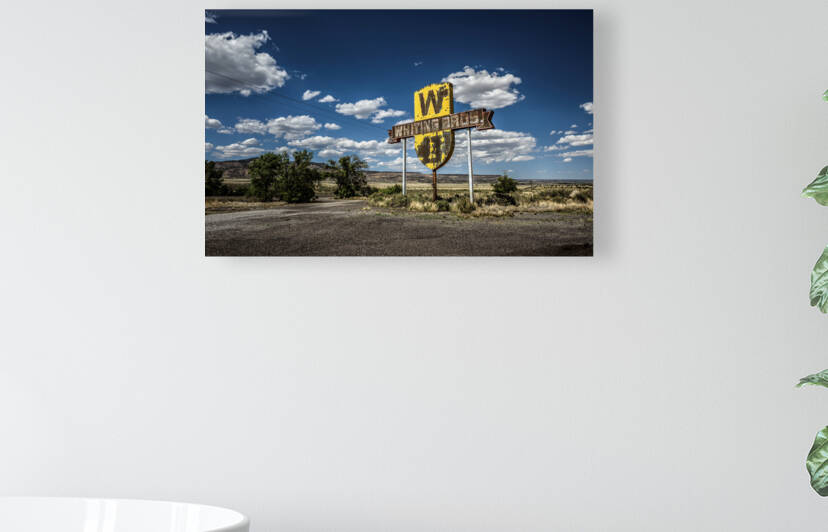 Vintage Whiting Bros sign above a removed gas station on Route 66 in New Mexico by Nick Fox