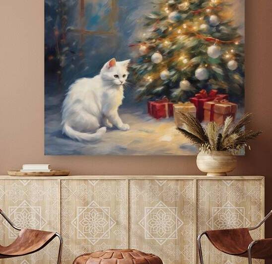 Cute white cut sat in front of the Christmas tree by Island Art Studio